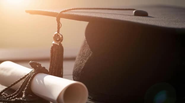 Picture of a square academic cap, graduate cap, or mortarboard and diploma.