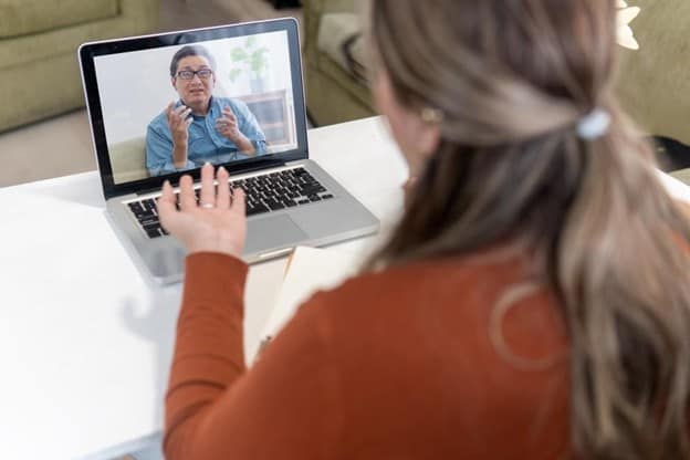 Provider talking to a patient on a computer for a telehealth visit.